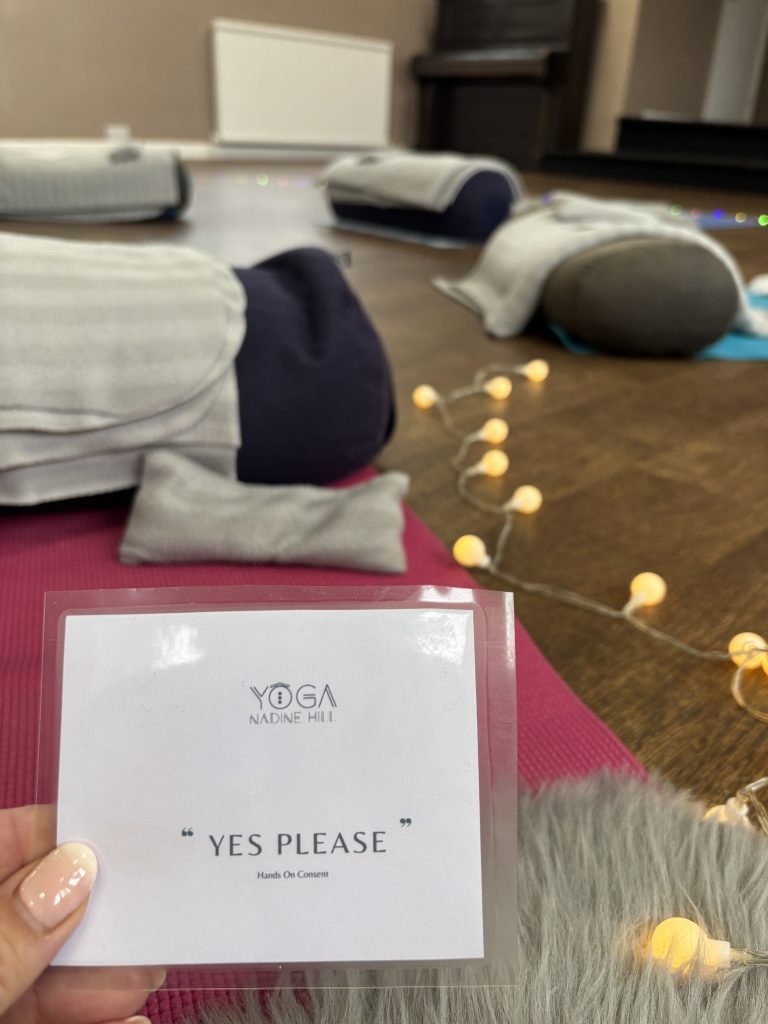 Yoga by Nadine Hill yes please cards shown against a background of fairy lights and bolsters and yoga mats laid out